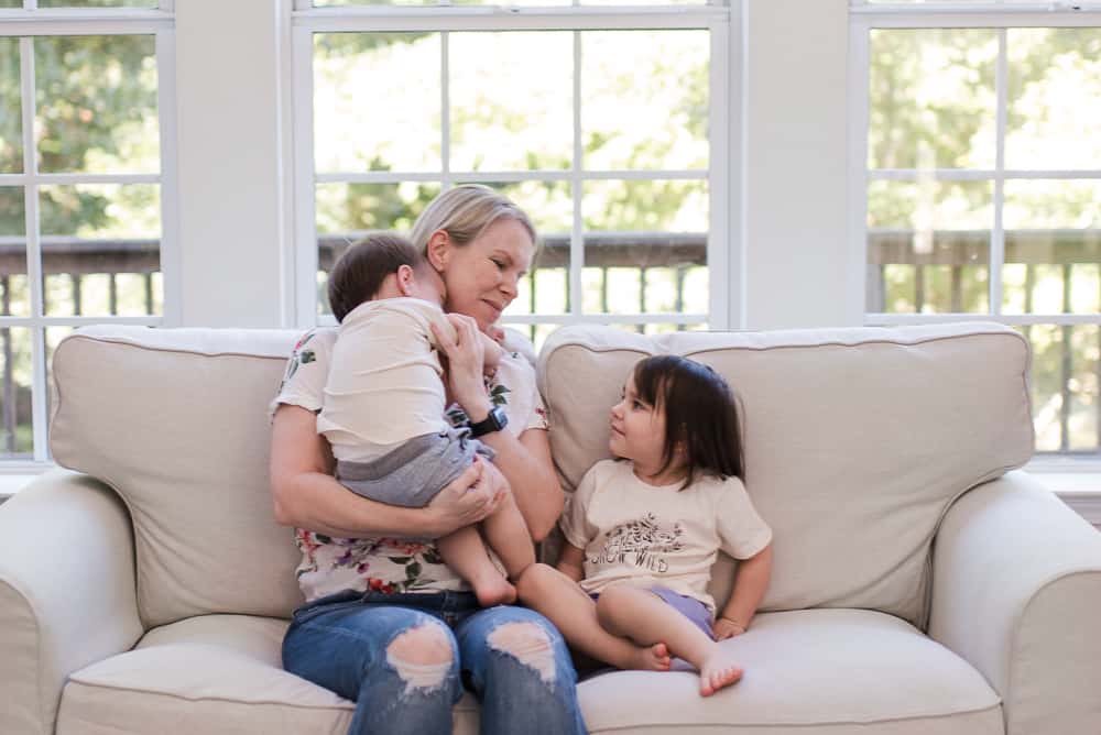 lifestyle blogger Amanda Seghetti on couch with babies