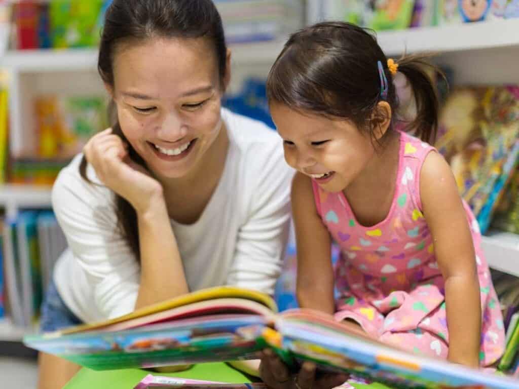 parent reading book with child