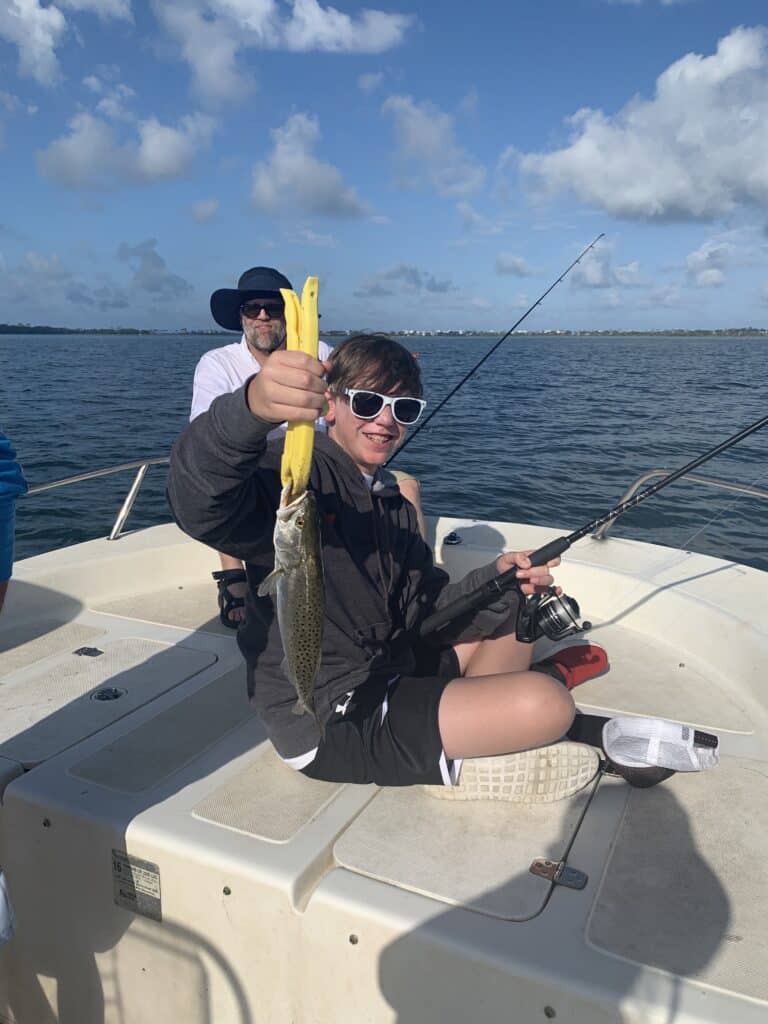 teen fishing on boat